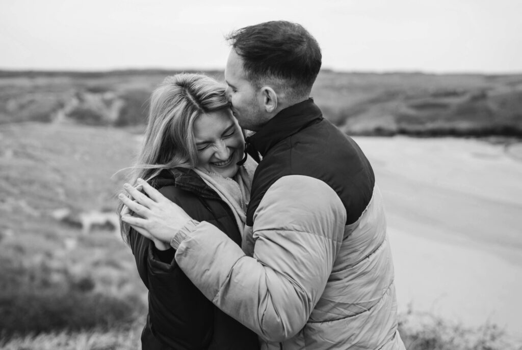 Engagement photoshoot of couple in beach at broad haven south, Pembrokeshire West Wales 