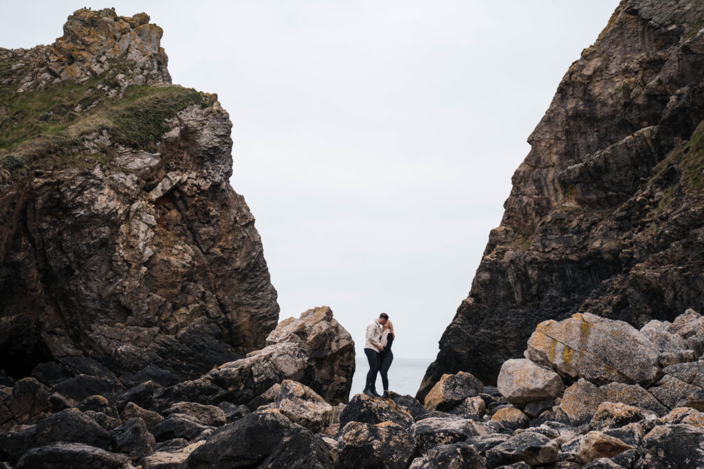 Engagement photoshoot of couple in rocks and broad haven south, Pembrokeshire West Wales 