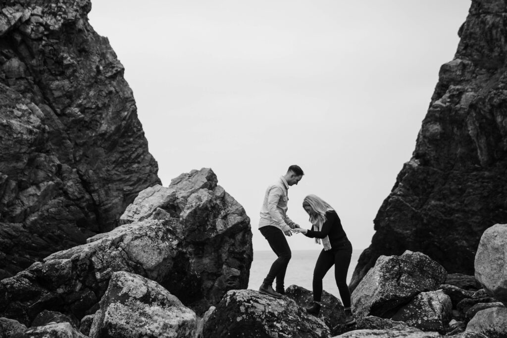 Engagement photoshoot of couple in rocks and broad haven south, Pembrokeshire West Wales 